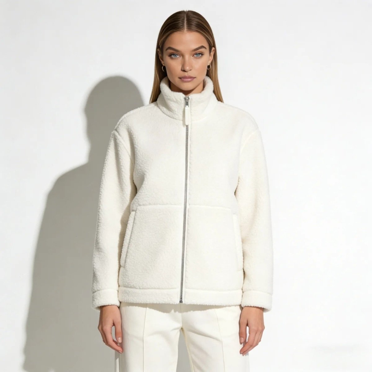 Model wearing the white Julie Sherpa Fleece Jacket by Kouvr Fashion, shown from the front against a white background.