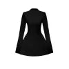 Woman wearing Kouvr Kaisha black long sleeve open-back mini dress in a stone archway