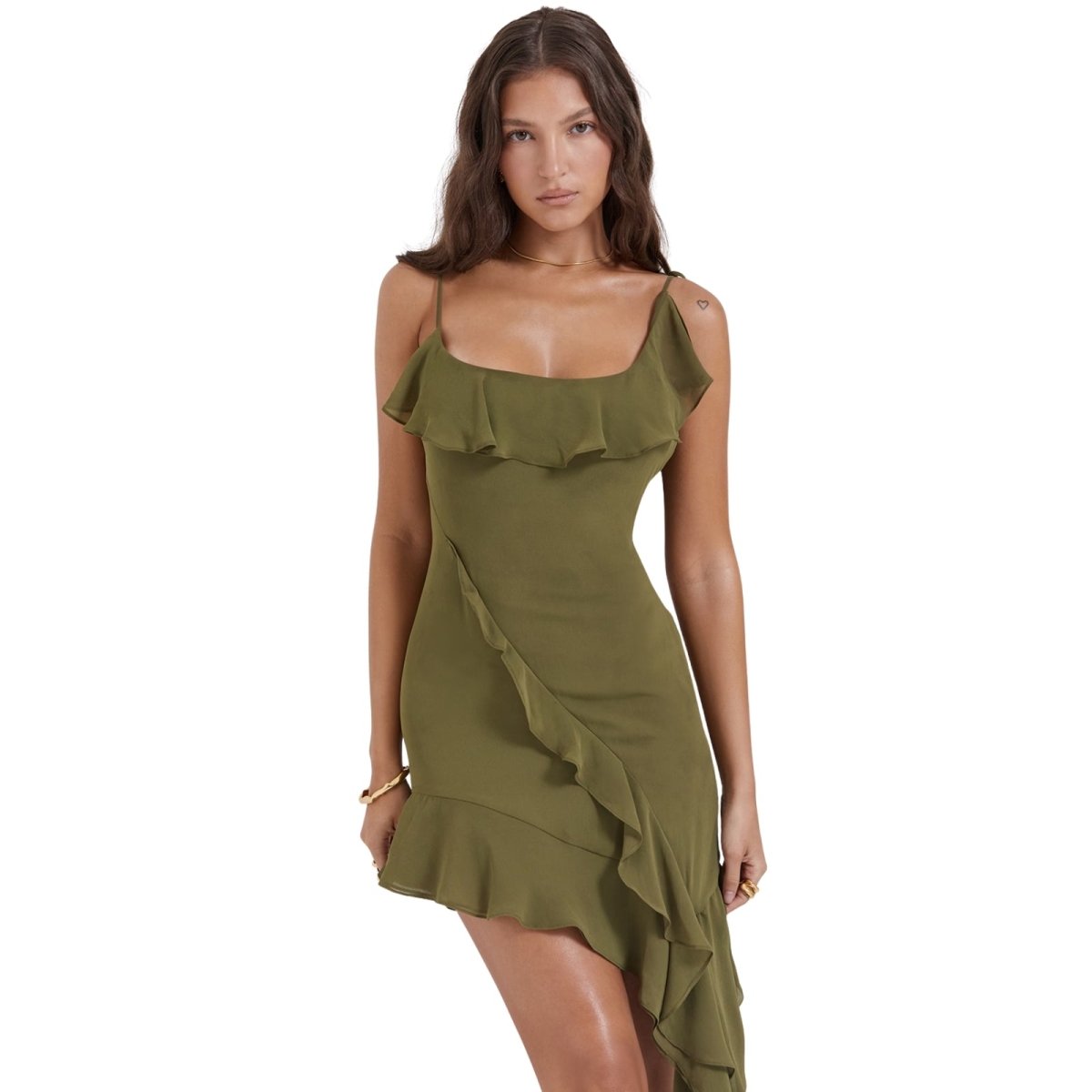 Woman wearing a olive dress with ruffled details on a white background