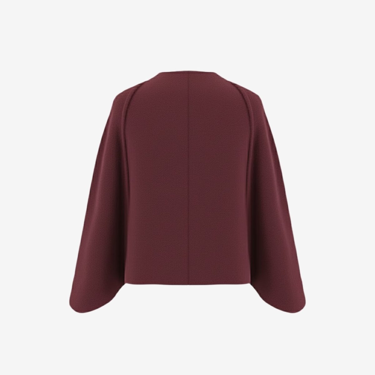  Flatlay product shot of the back of the Kouvr Laverne Structured Capelet, detailing the shoulder construction.