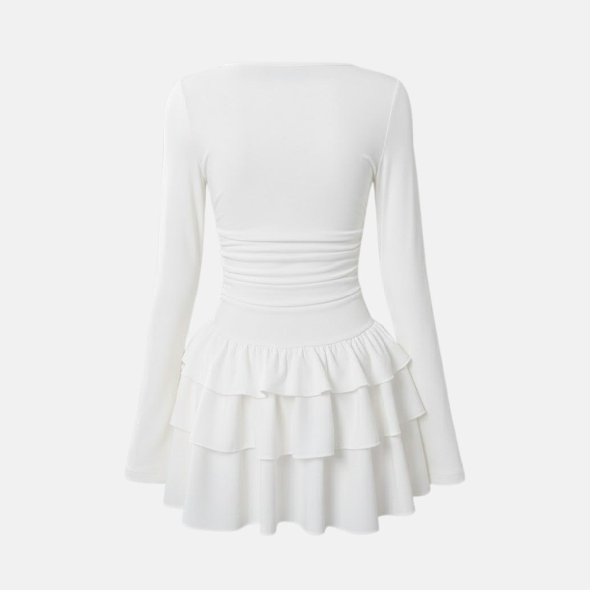Flatlay studio shot of the back of the Kouvr Leona white long sleeve tiered ruffle mini dress showing ruched waist detail.