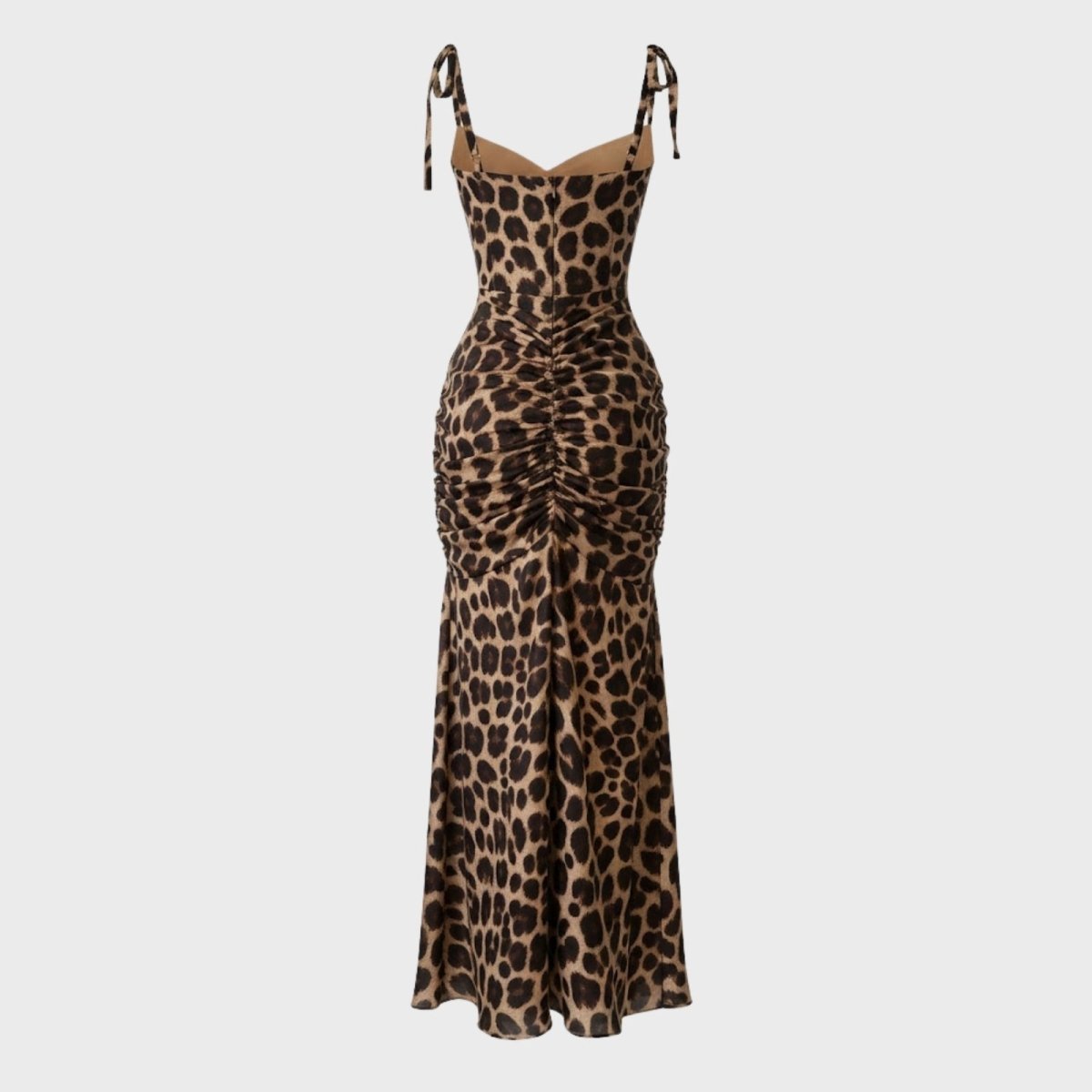 Flat lay image of the back of a leopard print maxi dress, detailing the full-body ruching and adjustable shoulder ties.
