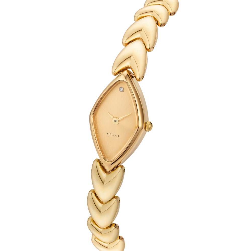 Gold Kouvr watch with braided strap on a white background