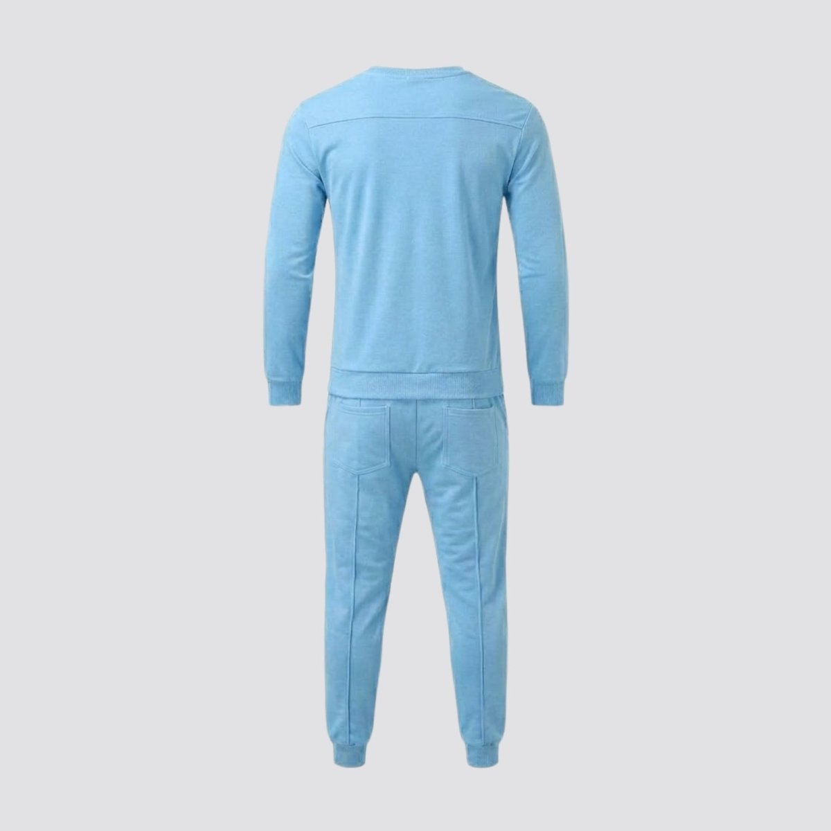 Back view flat lay of the Kouvr men's light blue tracksuit, detailing the rear yoke on the sweatshirt and the back patch pockets on the joggers.