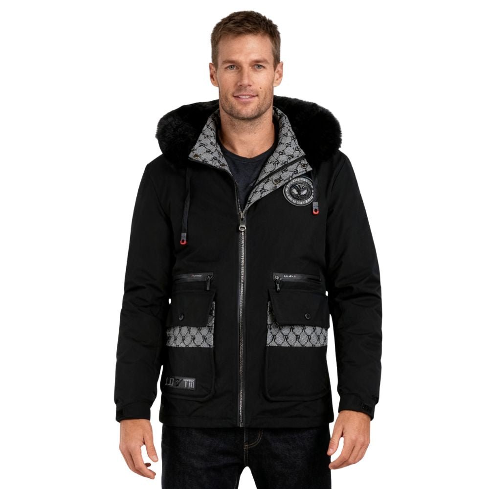 Man wearing a black kouvr jacket with fur-lined hood on a white background