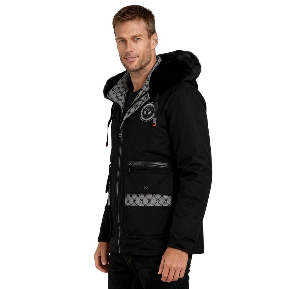 Man wearing a black kouvr jacket with patterned lining on a white background