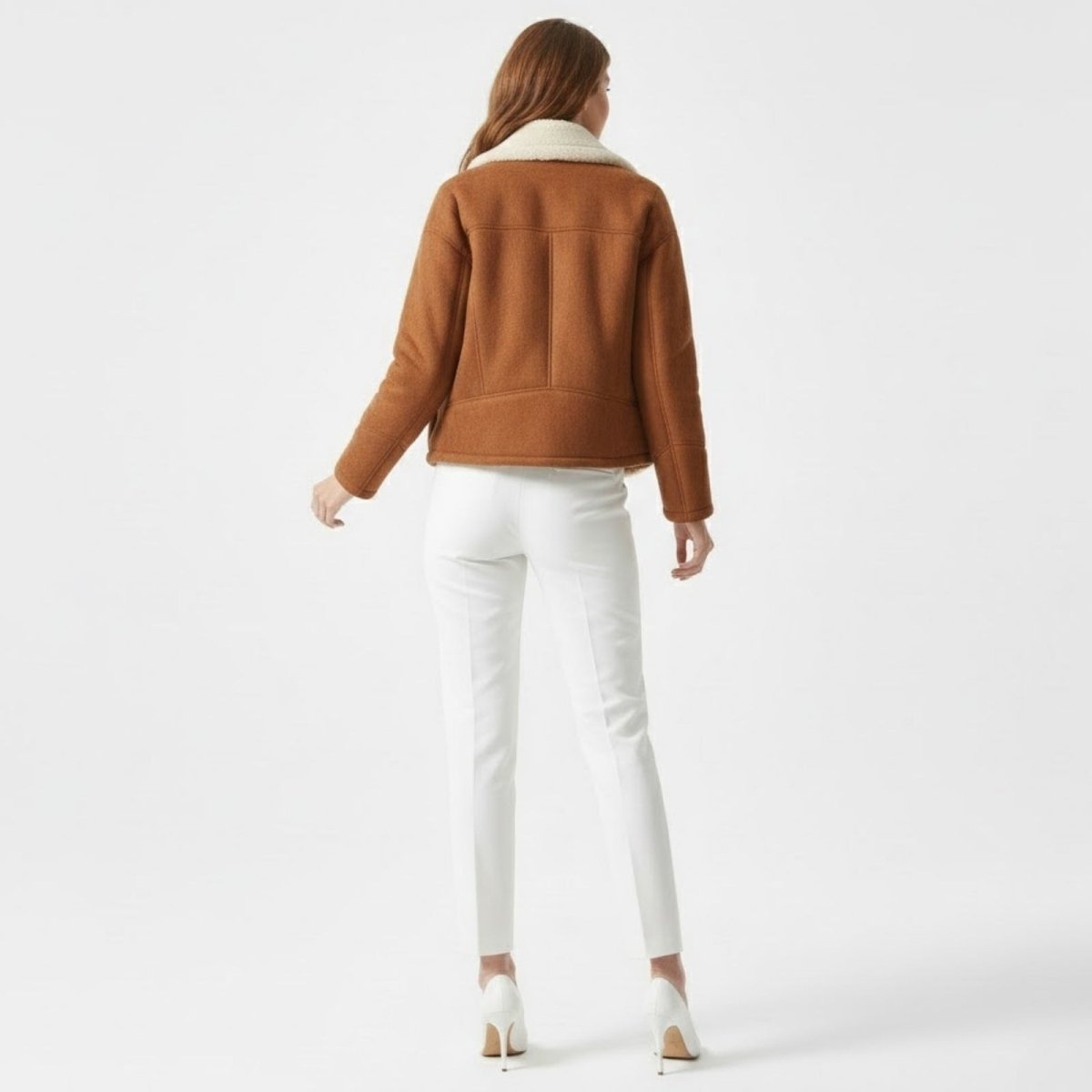Back view of the Kouvr Loretta cognac brown women's shearling jacket, highlighting the panel seam details. 