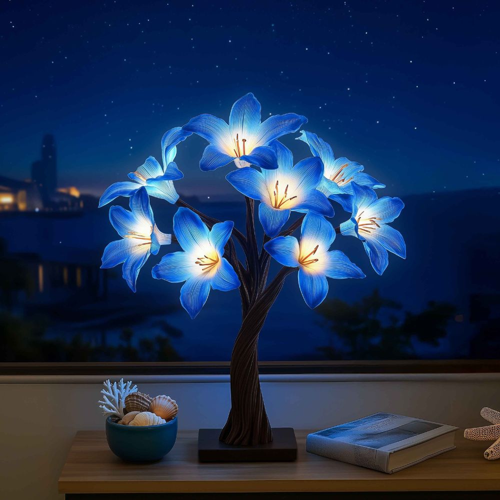 Kouvr Starfall Lily Tree in Luminous providing ambient light on a modern wooden desk at night