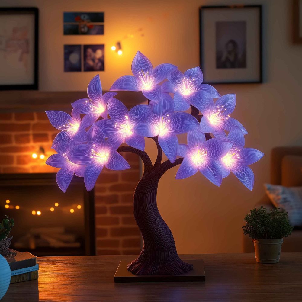 Kouvr Starfall Lily Tree in Luminous providing ambient light on a modern wooden desk at night