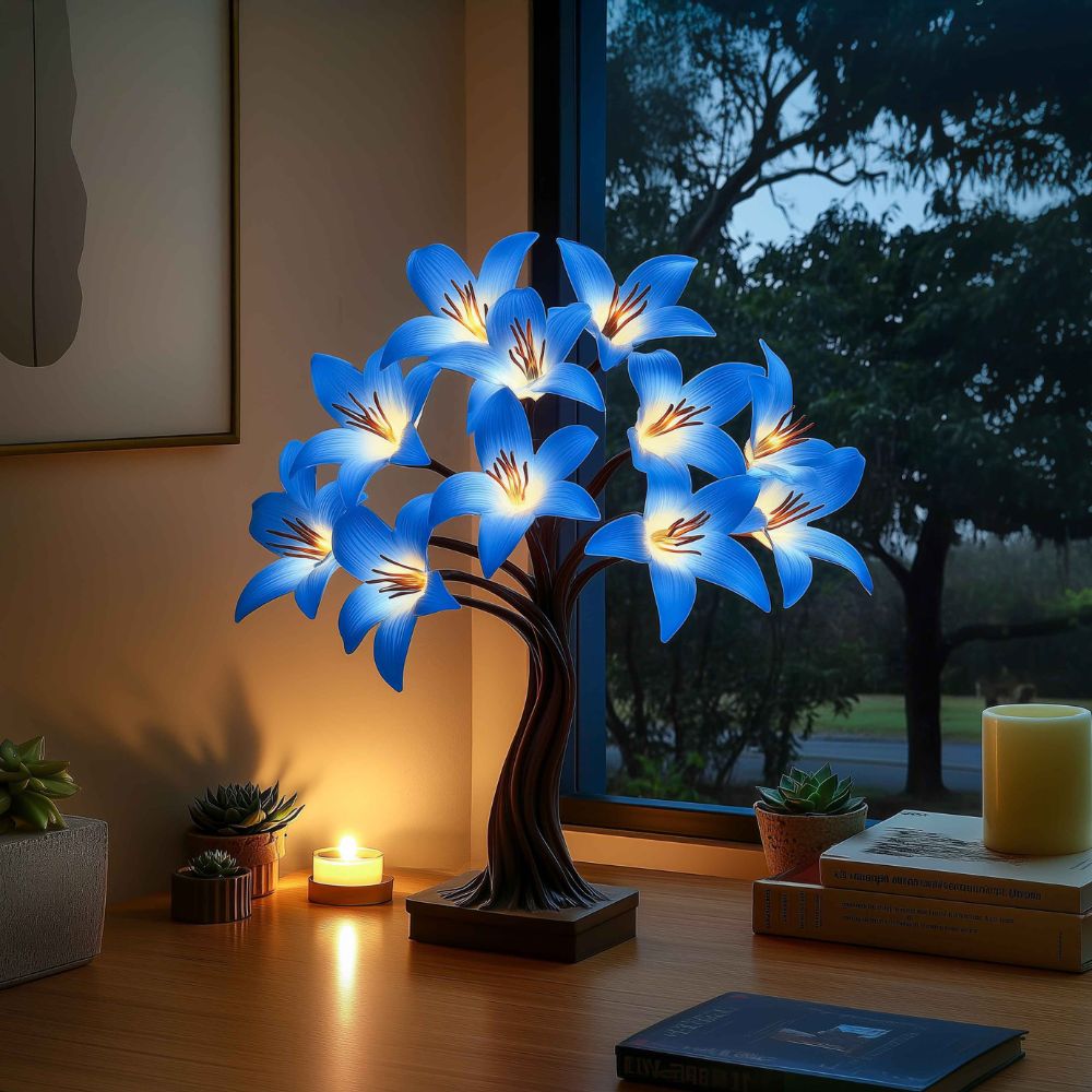 Kouvr Starfall Lily Tree in Luminous providing ambient light on a modern wooden desk at night