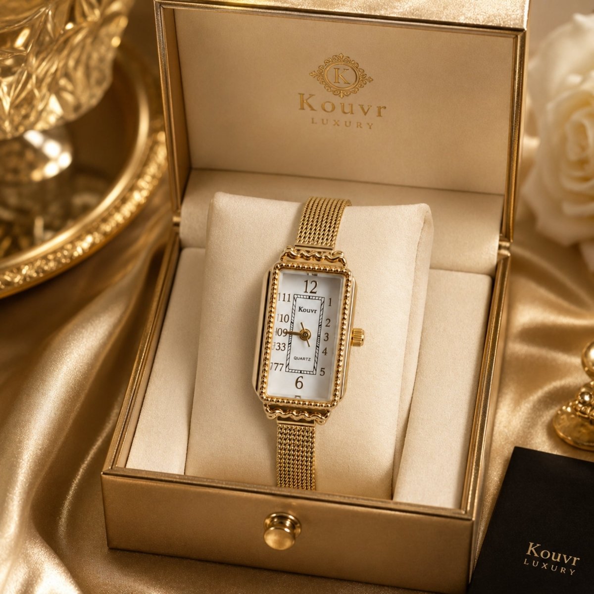 Kouvr luxury vintage rectangular women's gold watch resting elegantly inside a premium gold presentation box.