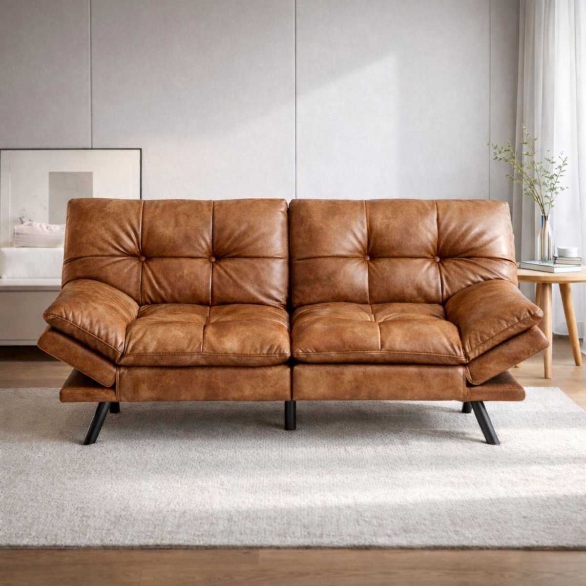 Cognac brown leather sleeper sofa in a bright apartment, showcasing biscuit tufting and adjustable armrests in the upright position.