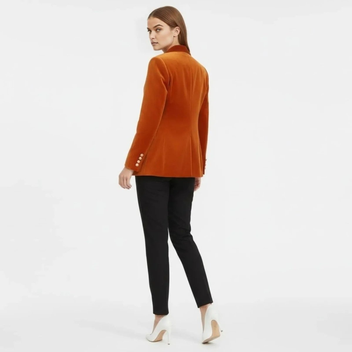 Back view of the Kouvr Maribel tailored velvet blazer in rust, highlighting the single vent and structured silhouette.
