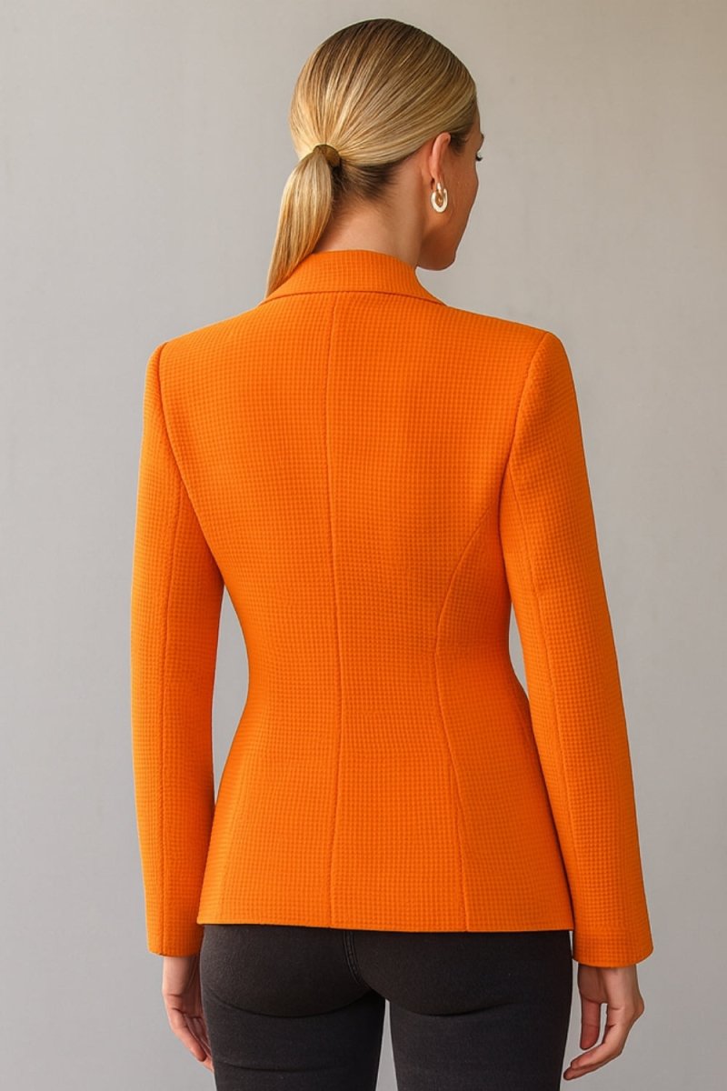 single-breasted tailored jacket," "vibrant orange power blazer," "luxury workwear for women," "statement office jacket," "basket-weave fabric," "impeccable tailoring," "transitional outerwear," "professional women's clothing