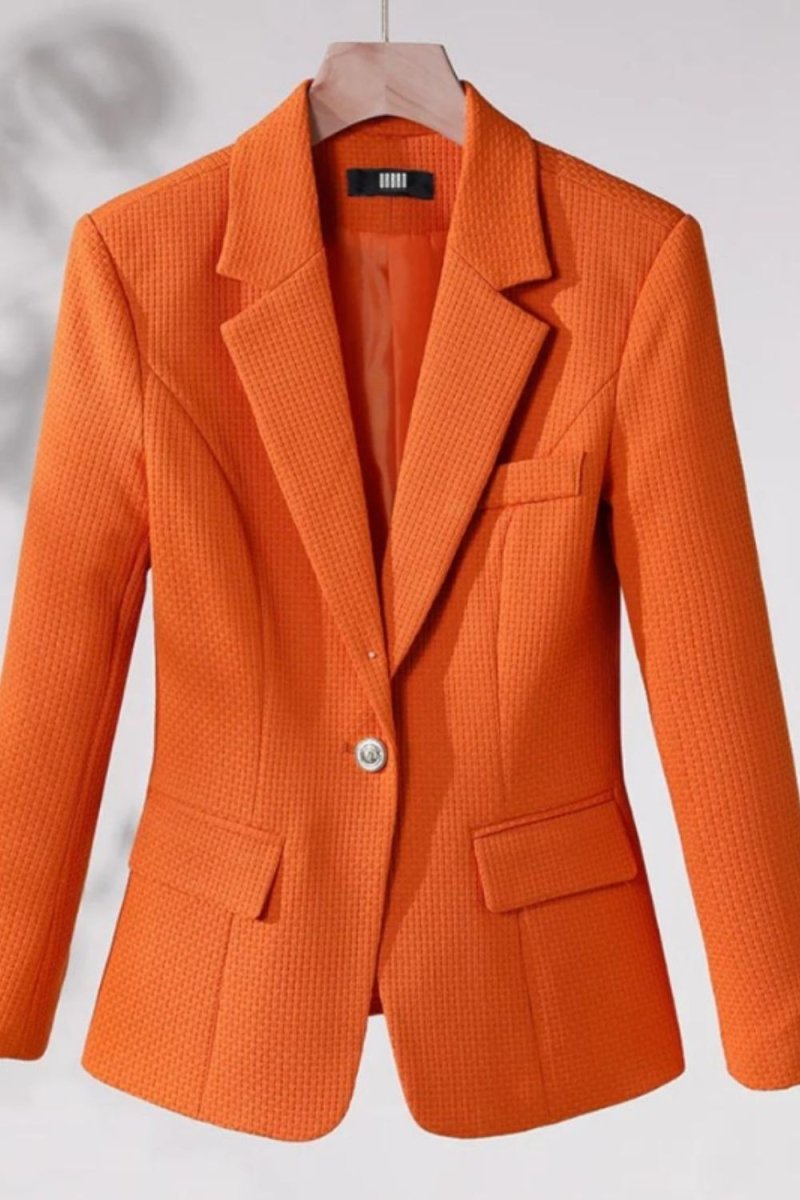 single-breasted tailored jacket," "vibrant orange power blazer," "luxury workwear for women," "statement office jacket," "basket-weave fabric," "impeccable tailoring," "transitional outerwear," "professional women's clothing