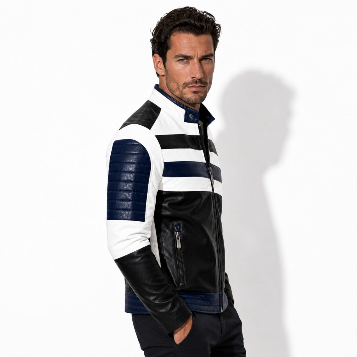 Side profile of a man wearing the Kouvr slim fit color block biker jacket showing navy blue quilted sleeve detailing and heavy duty metal zippers.
