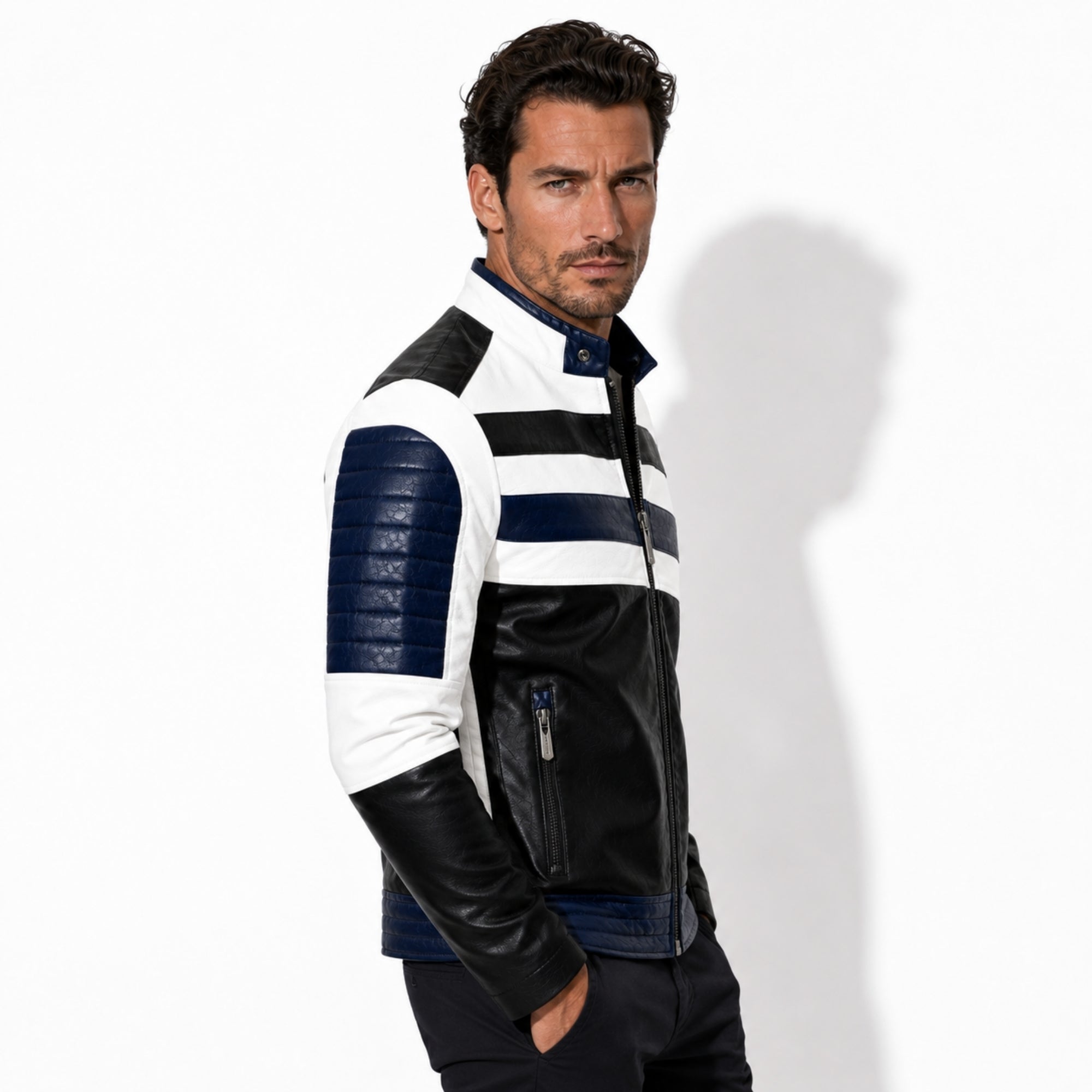 Side profile of a man wearing the Kouvr slim fit color block biker jacket showing navy blue quilted sleeve detailing and heavy duty metal zippers.