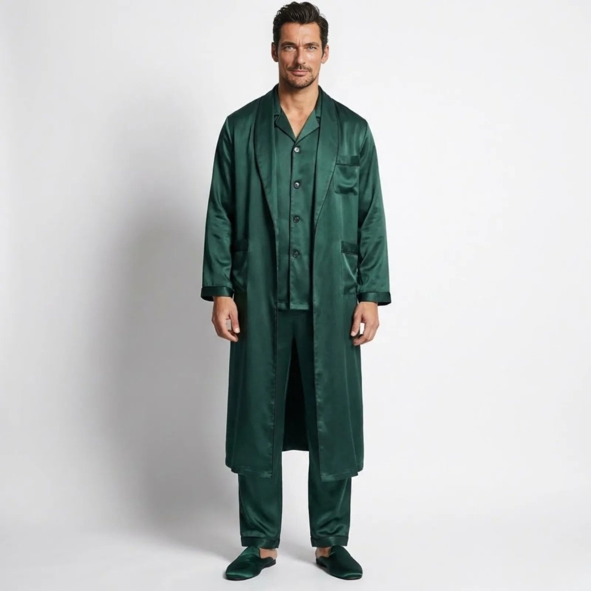 Male model wearing the full Kouvr three-piece green satin pajama set with a long robe, viewed from the front against a white background.