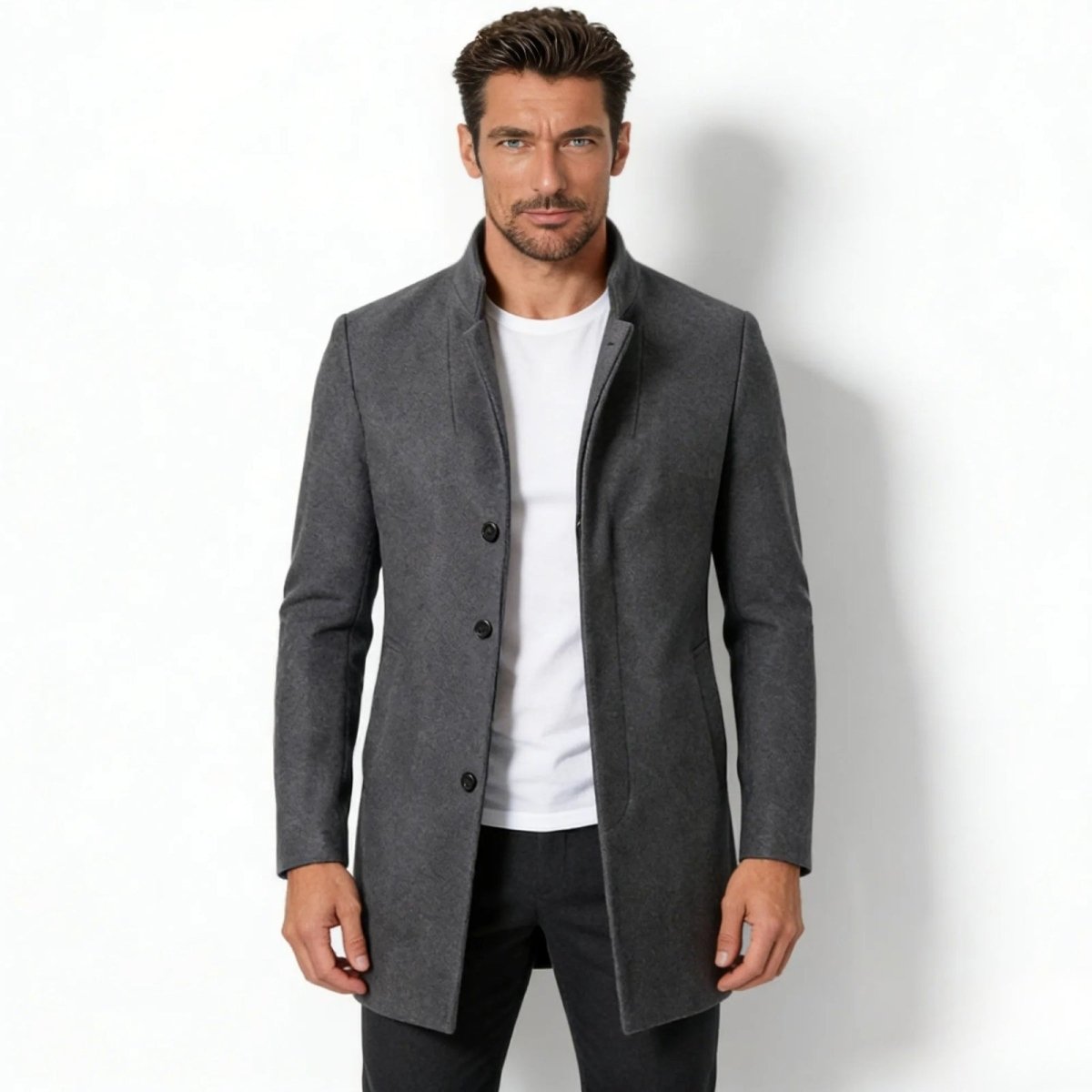 Model wearing the Kouvr Fashion men's charcoal grey wool blend stand collar overcoat in a slim fit, shown from the front over a white t-shirt. 