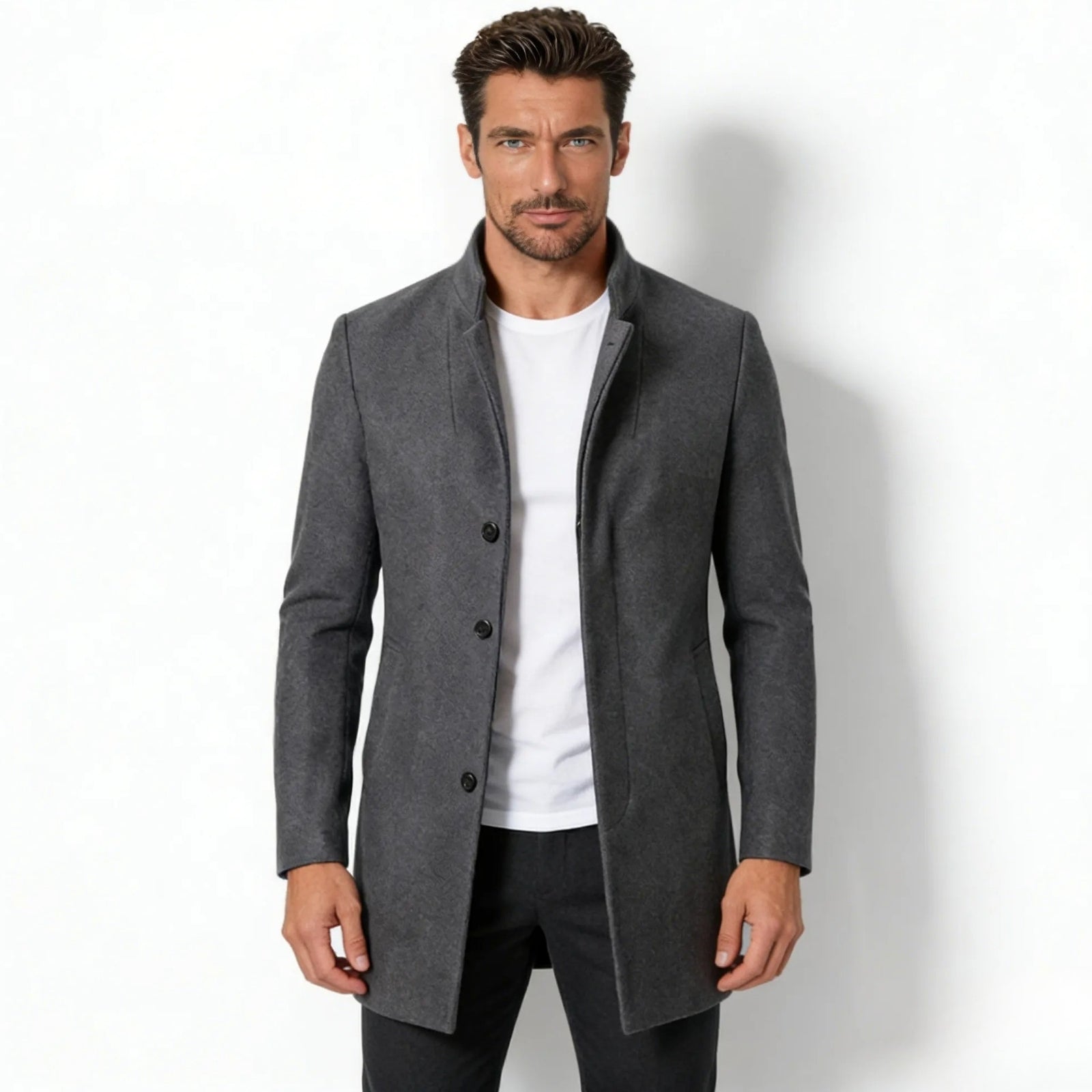 Model wearing the Kouvr Fashion men's charcoal grey wool blend stand collar overcoat in a slim fit, shown from the front over a white t-shirt. 