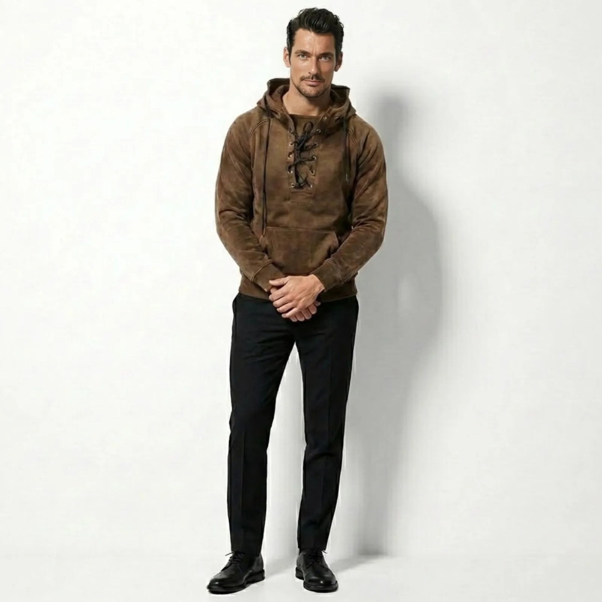 Model wearing the Kouvr men's khaki suede lace-up hoodie, front view, paired with black trousers.