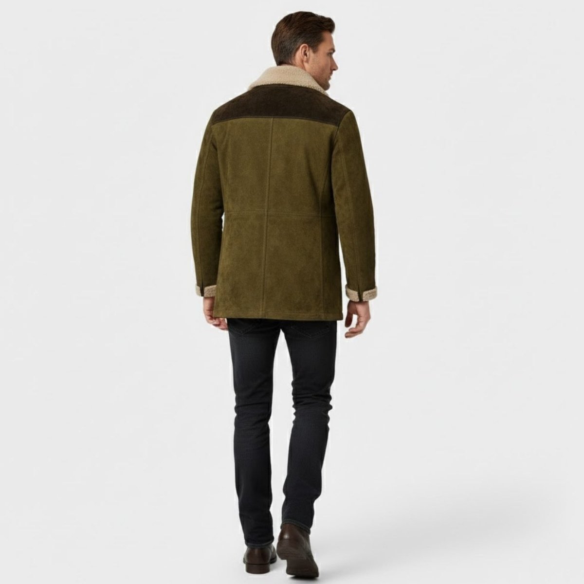 Back view of a male model wearing the Kouvr olive green suede jacket with its contrasting dark brown shoulder yoke.
