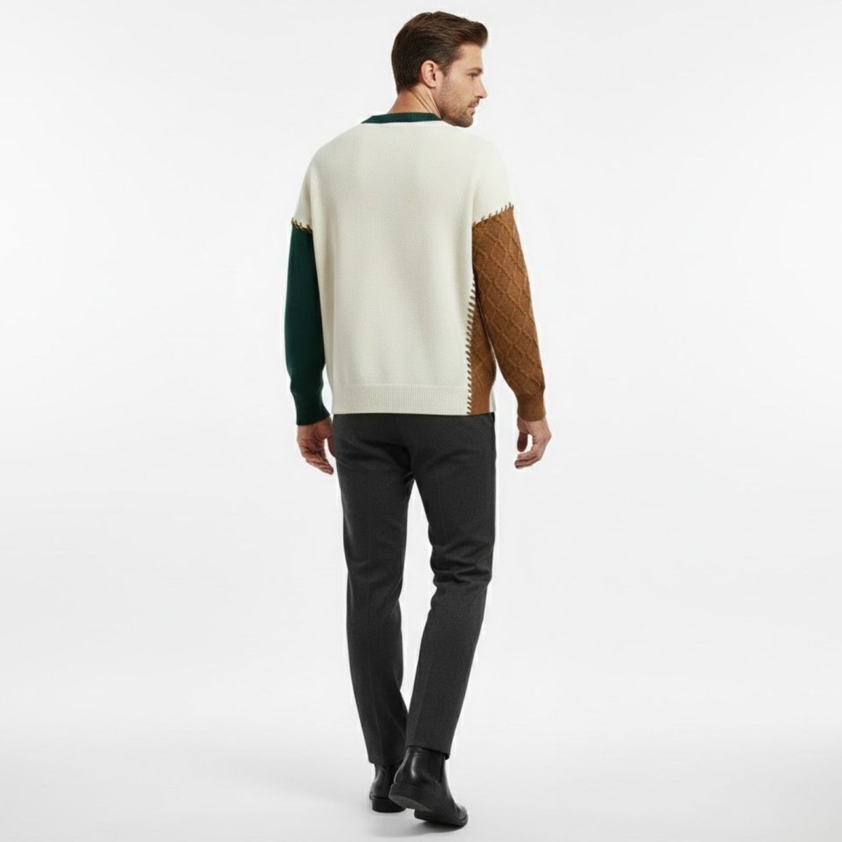 Back view of the Kouvr deconstructed sweater on a model, highlighting the brown diamond knit sleeve and ivory body with exposed stitching.