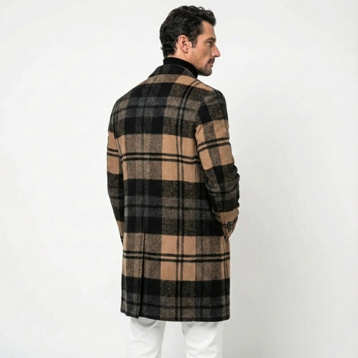 Back view of a male model in the Kouvr tan and black plaid winter coat, highlighting the single back vent and pattern alignment.