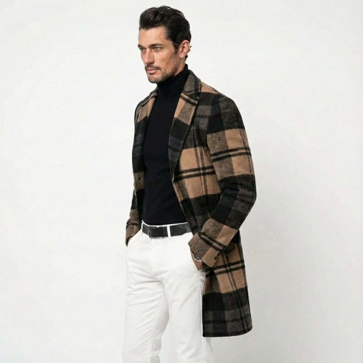 Side profile of a male model wearing the Kouvr tan and black checkered topcoat, showing its tailored fit and knee-length cut.