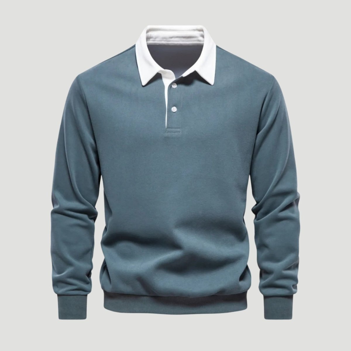 Flatlay studio shot of the front of a men's grey blue polo sweatshirt, detailing the three-button placket and white contrast collar.