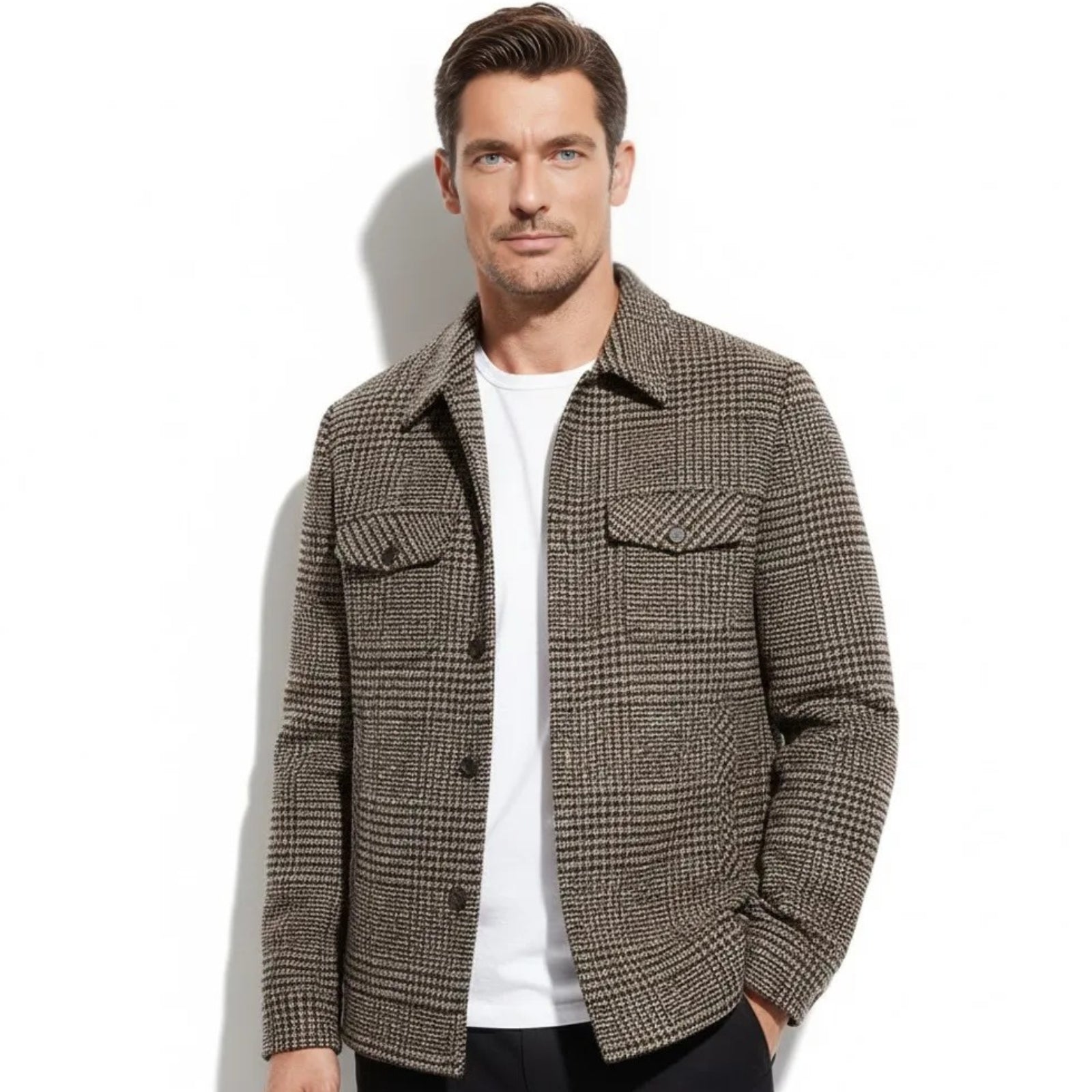 Model wearing the Kouvr men's brown and black houndstooth wool shacket layered over a white t-shirt and black pants.