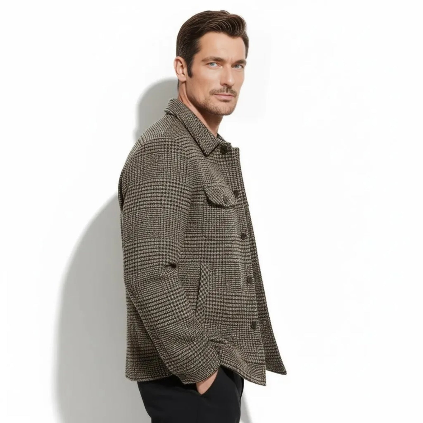 Side profile of a man wearing the Kouvr wool-blend overshirt in a brown houndstooth pattern, showing the fit and sleeve length.