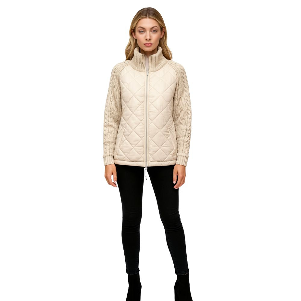 Woman wearing the Kouvr Mika khaki quilted jacket with cable knit sleeves, styled with black jeans