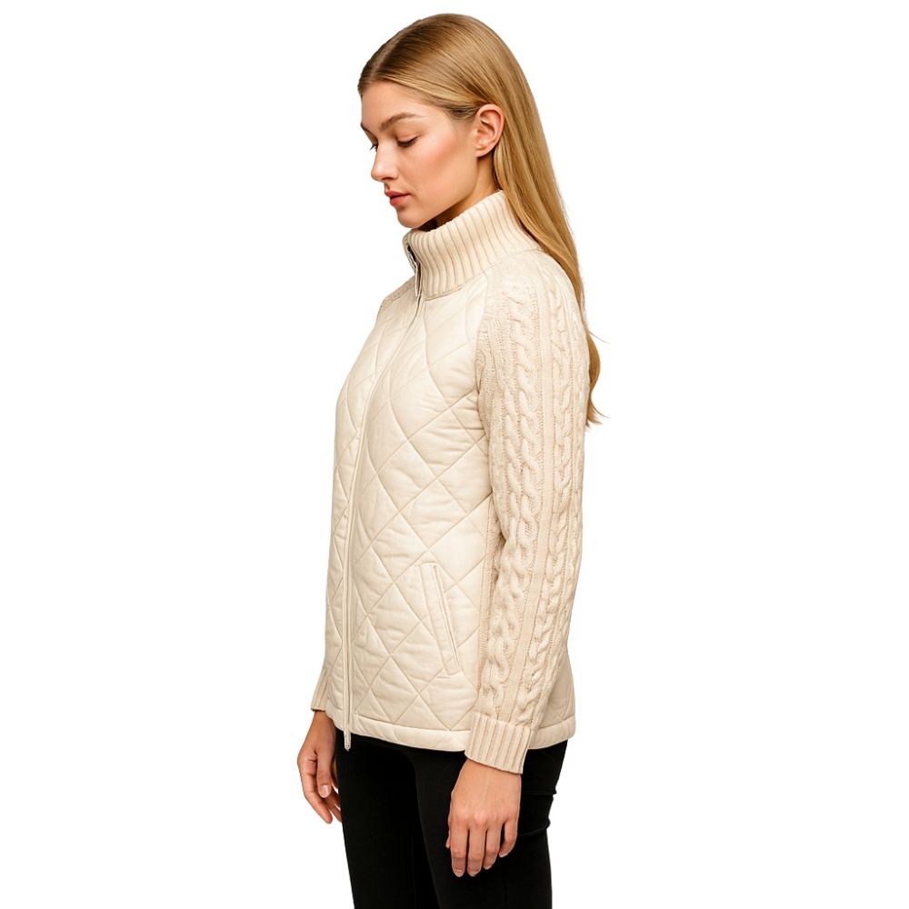 Woman wearing the Kouvr Mika khaki quilted jacket with cable knit sleeves, styled with black jeans