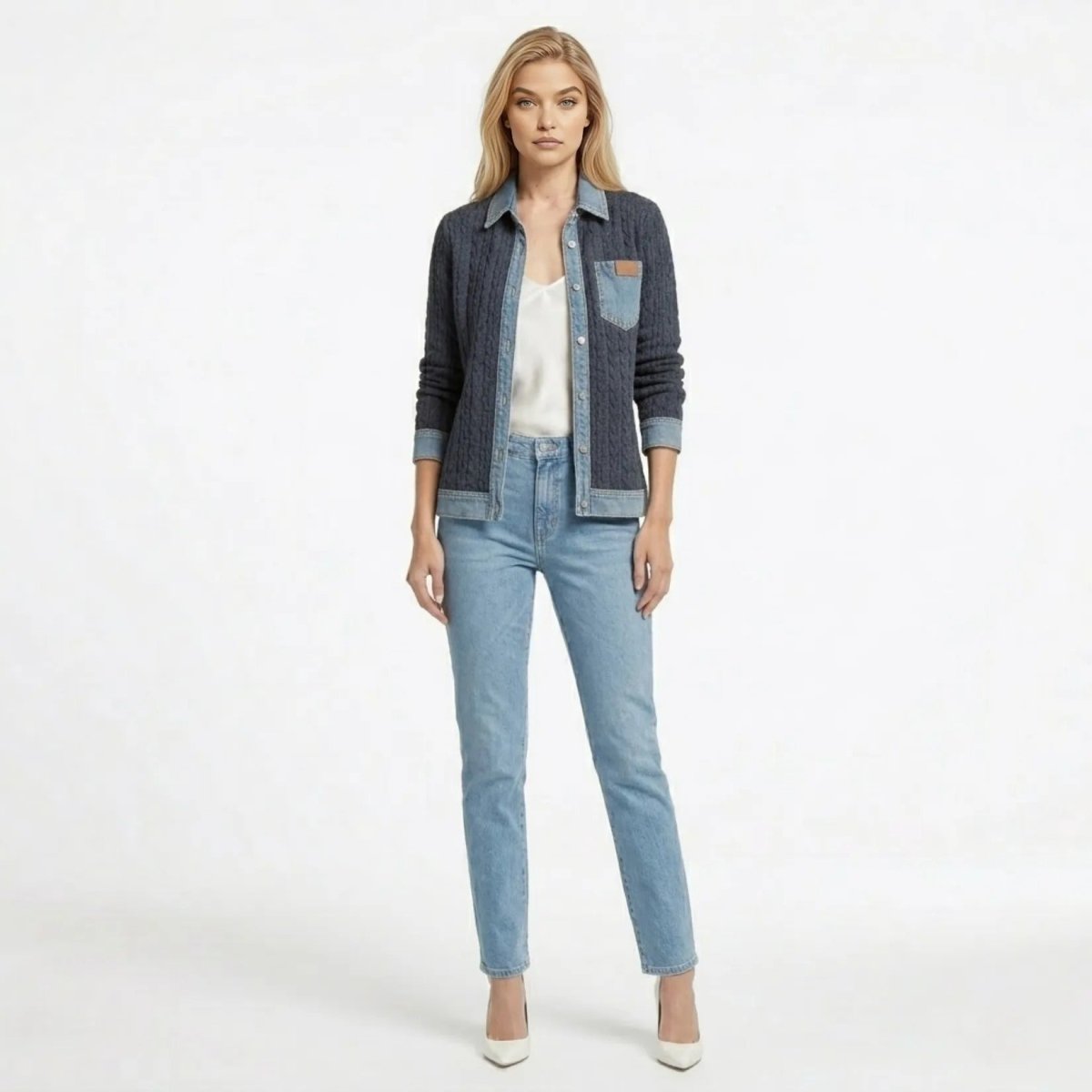 Woman wearing Kouvr mixed media navy cable knit and light wash denim button-up shacket over a white camisole and jeans.