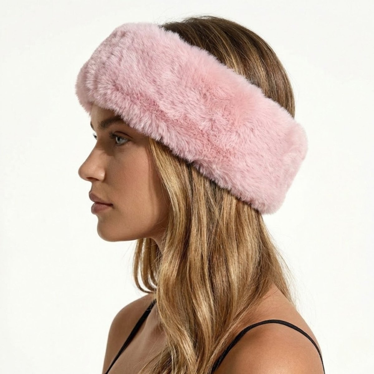 Side profile of a model wearing the Kouvr Nancie  plush pink faux fur winter headband.