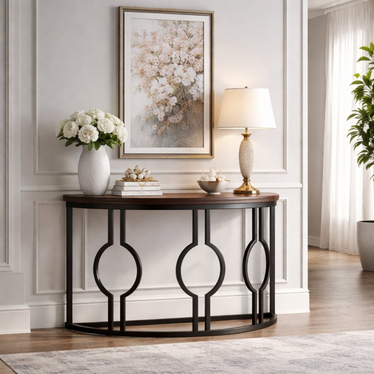 Modern entryway design featuring the Kouvr geometric console table against a white wall with wainscoting, styled with white florals and books.