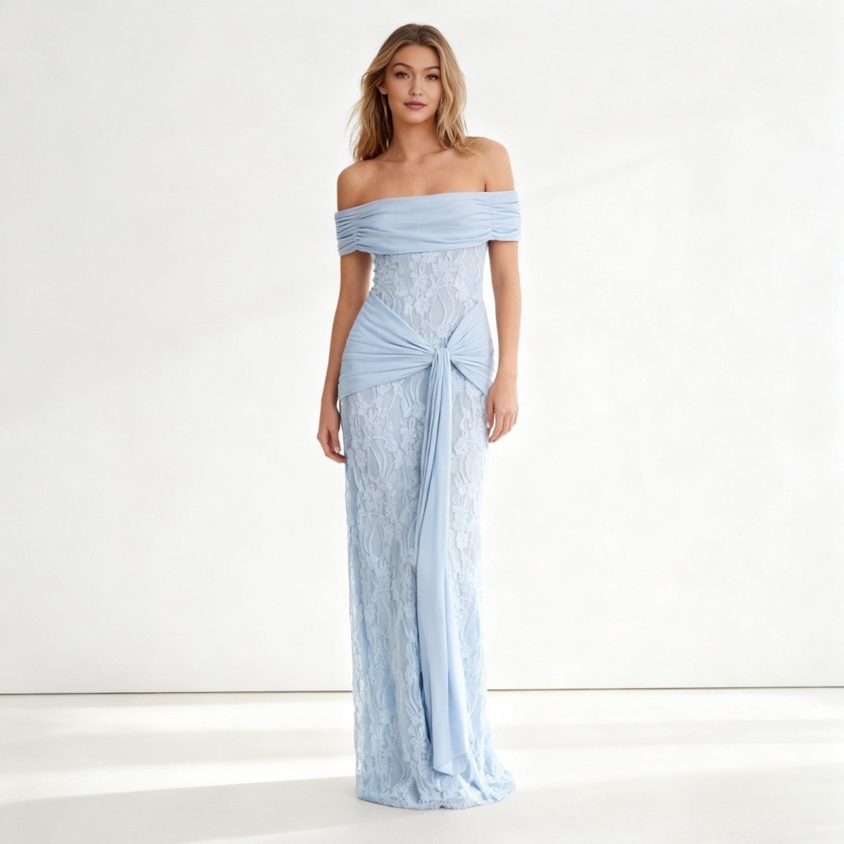 Woman wearing a light blue Kouvr off-shoulder gown on a white background