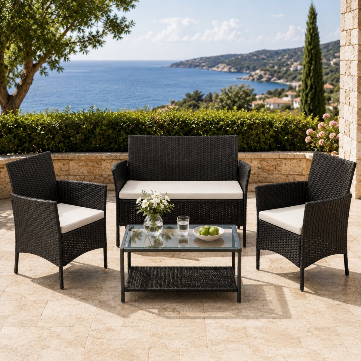 Friends laughing and enjoying drinks on the Kouvr all-weather outdoor rattan conversation set in a beautifully landscaped sunny courtyard setting.