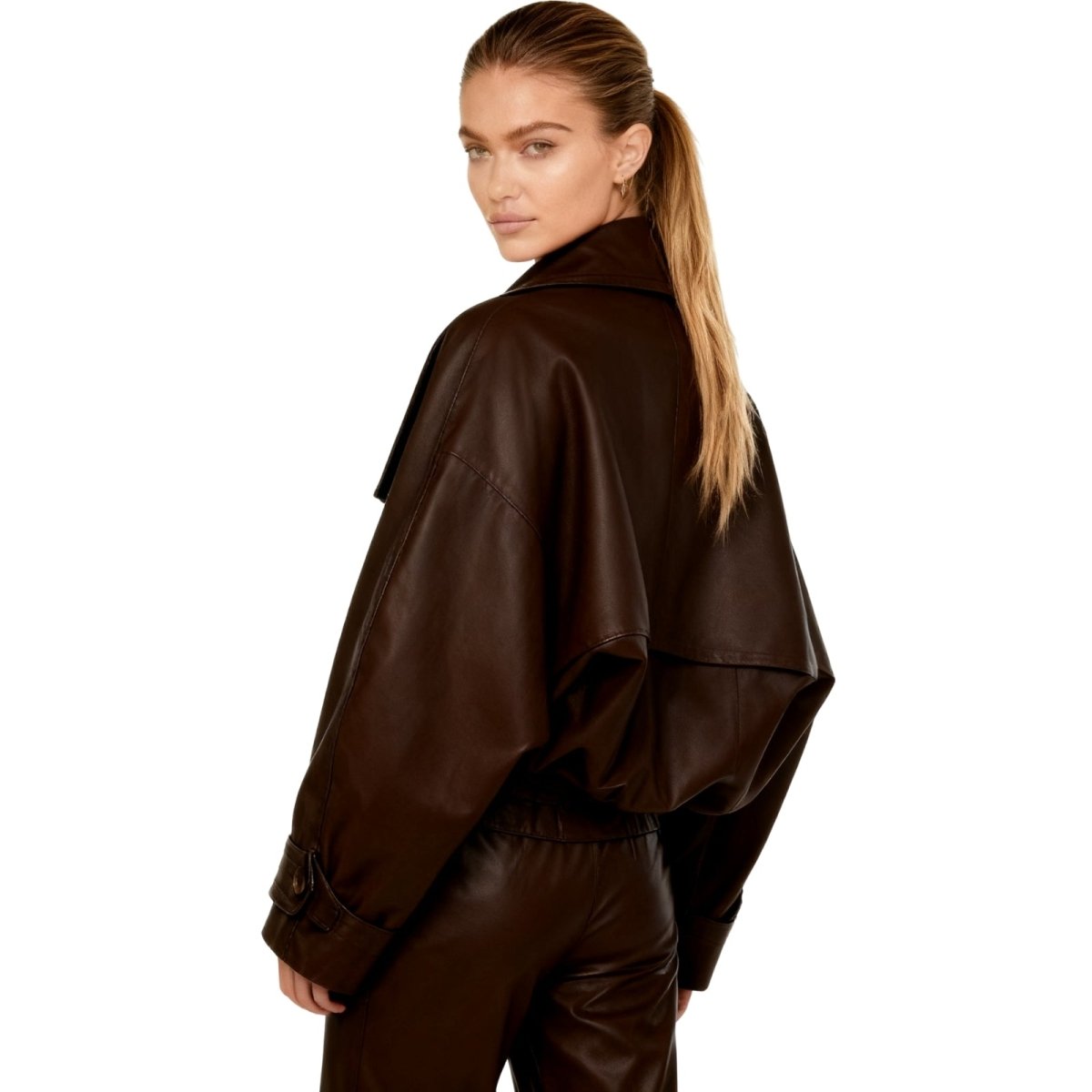 Model wearing the Kouvr Patricia oversized faux leather cropped trench jacket in dark brown