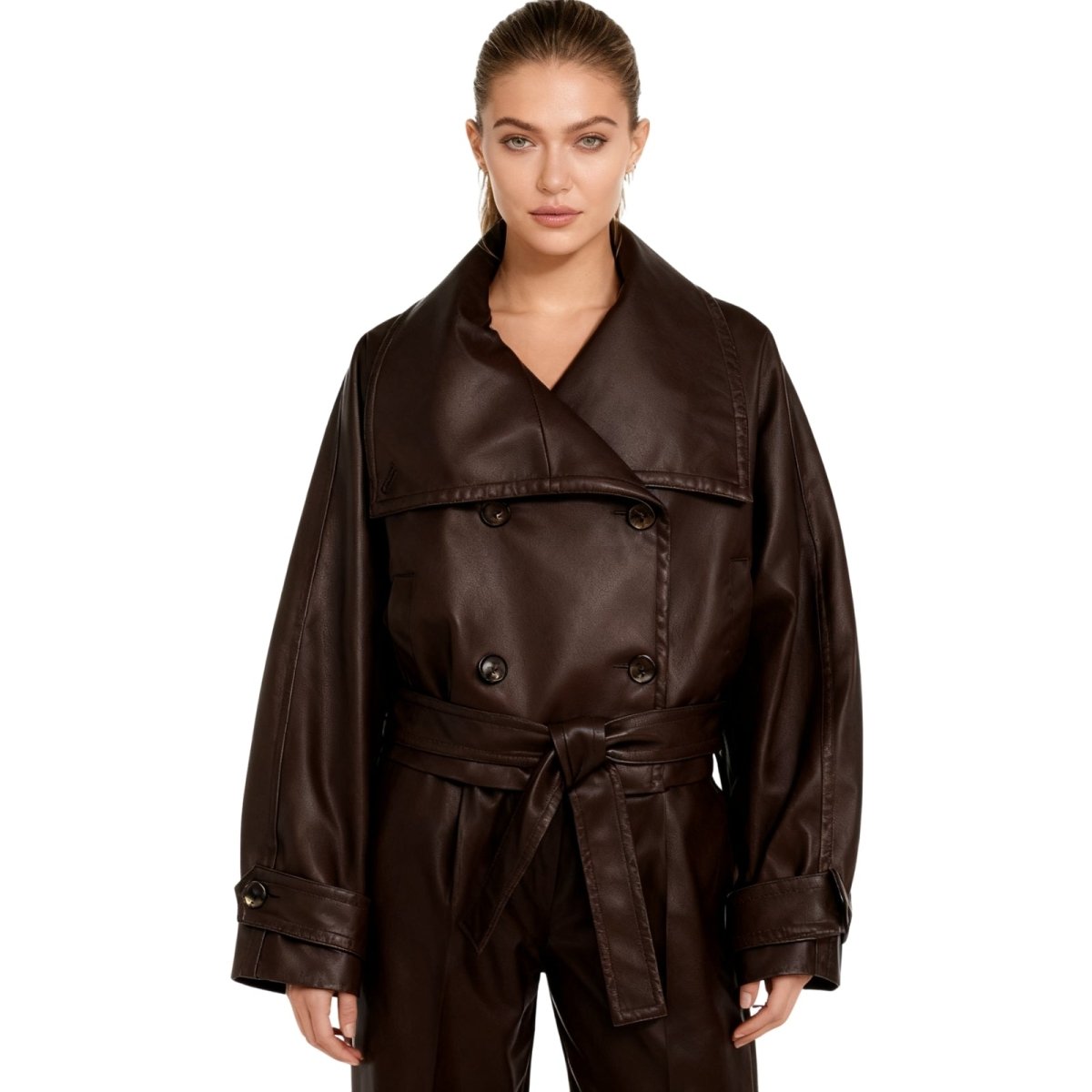 Model wearing the Kouvr Patricia oversized faux leather cropped trench jacket in dark brown