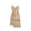 Flatlay of a V-neck gold sequin dress with asymmetrical fringe, highlighting the ruched texture.