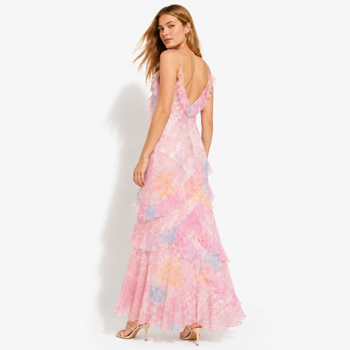Model showing the back of the pink Kouvr formal evening gown highlighting ruffle details and fit