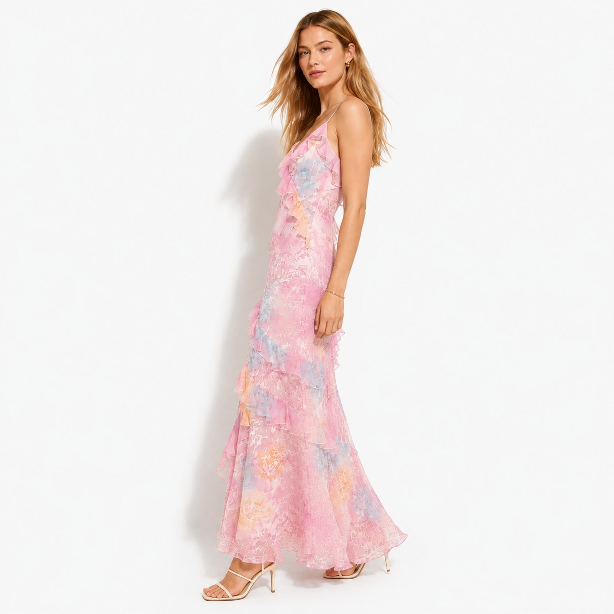 Side angle of the Kouvr pink floral romantic garden party dress in motion showing fabric flow