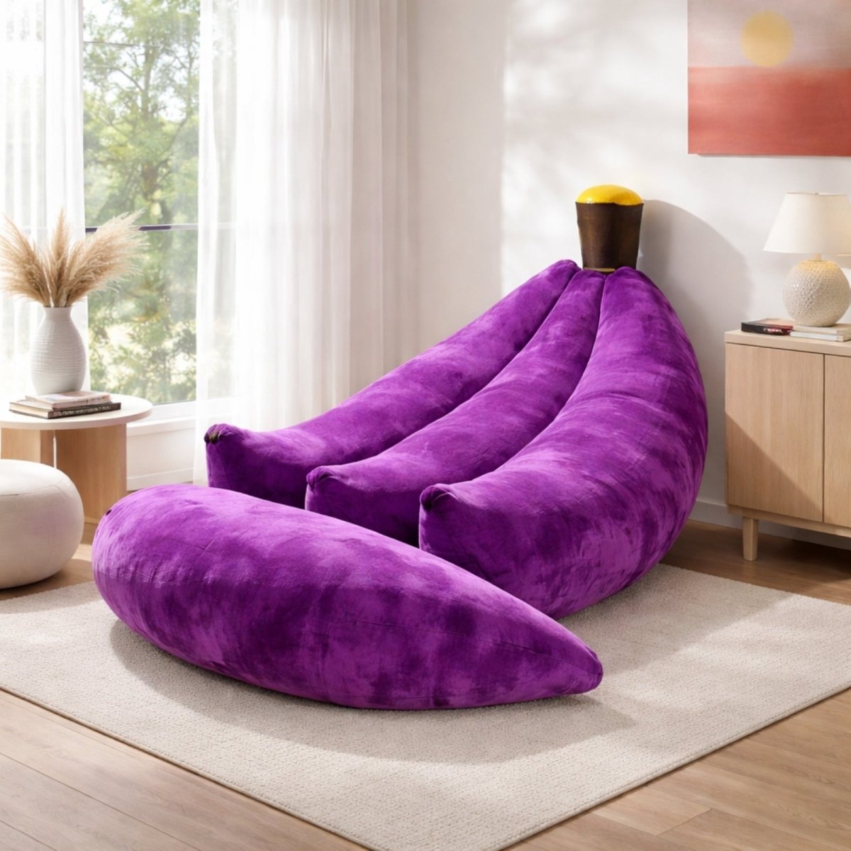 Deep purple velvet floor lounger in banana shape with peel flaps open, showcasing ergonomic curve for reading nooks.