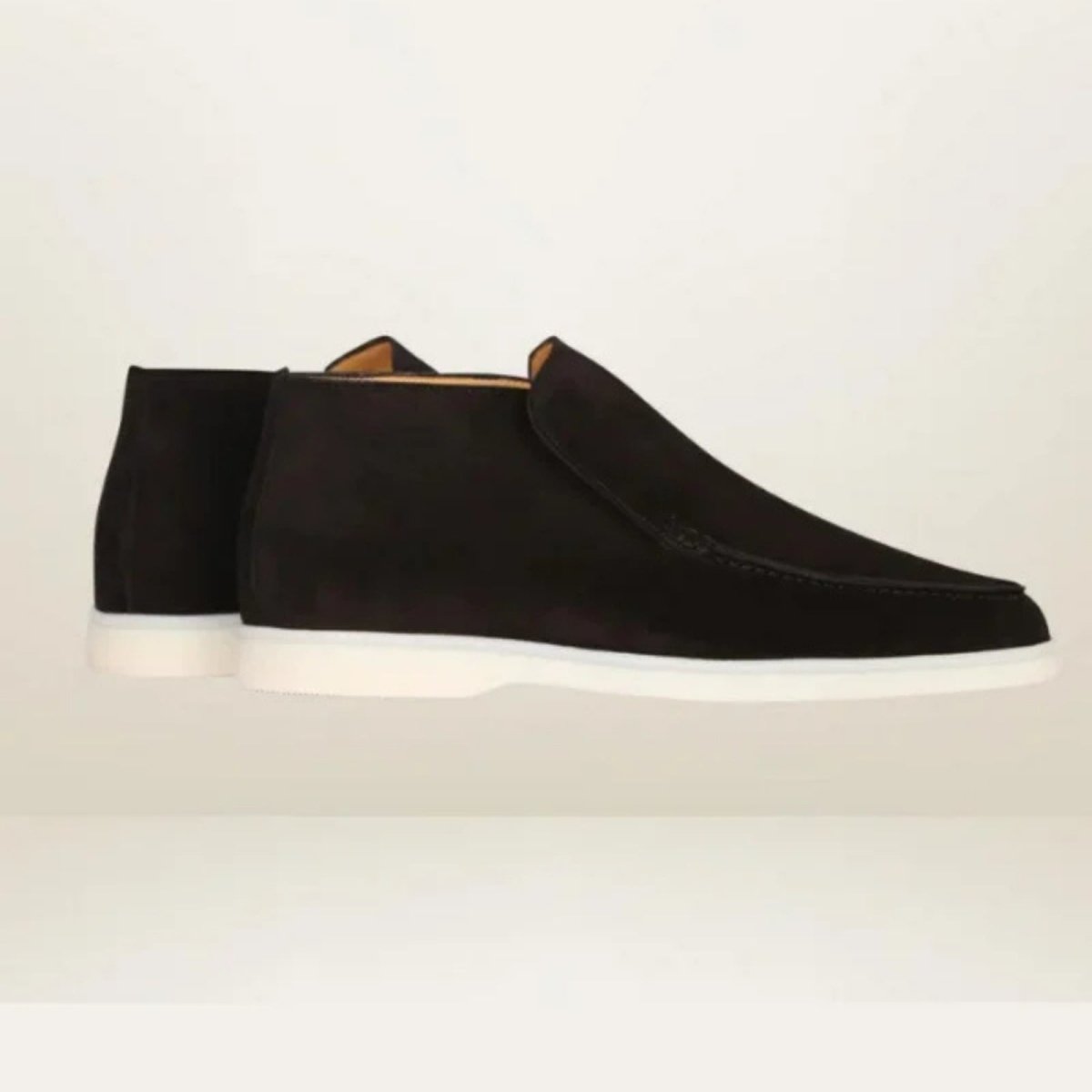 Product shot of the Kouvr Ralph men's black suede slip-on chukka boot with a durable white rubber sole on a clean white background.