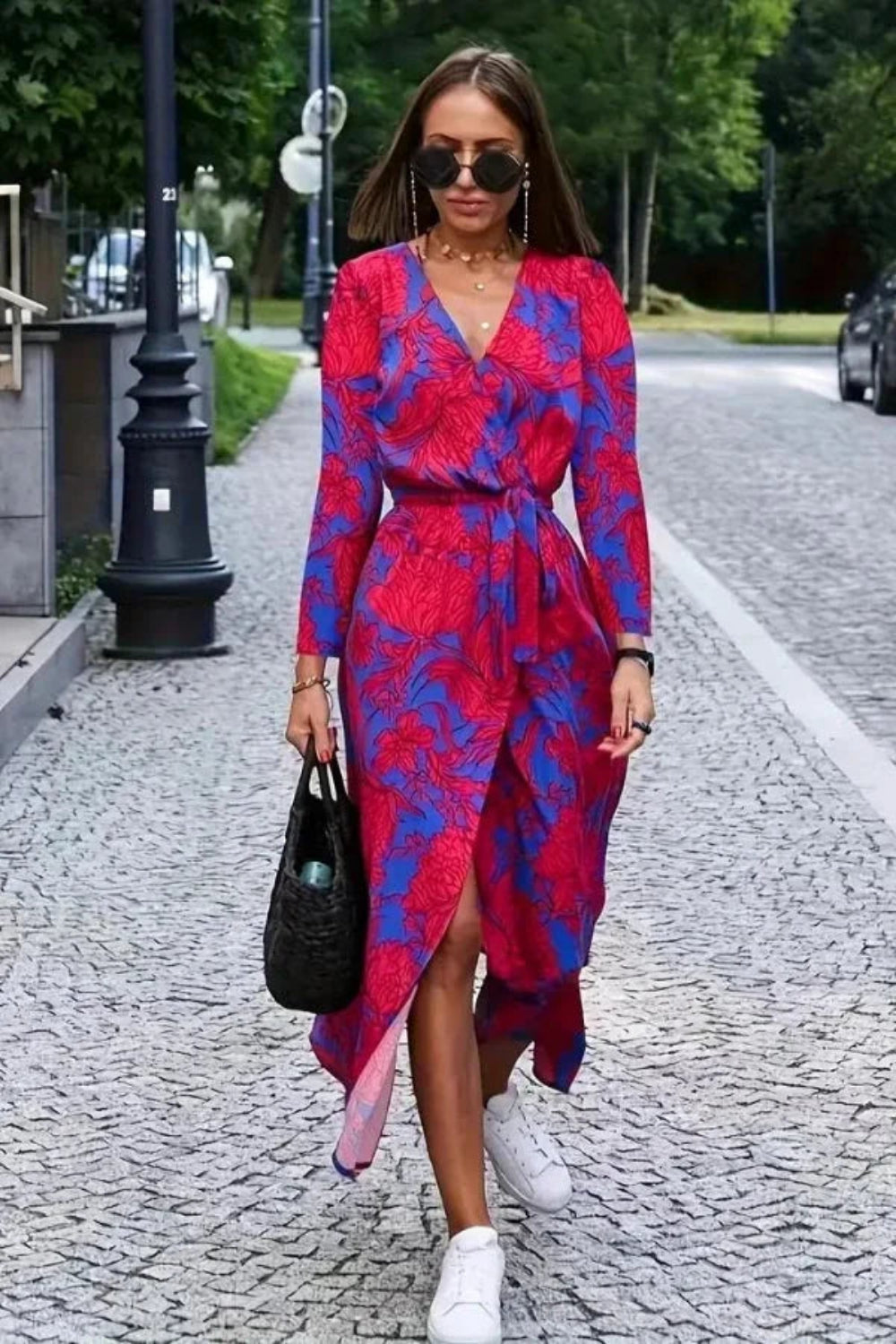 Model walking in Kouvr's red floral long sleeve wrap midi dress