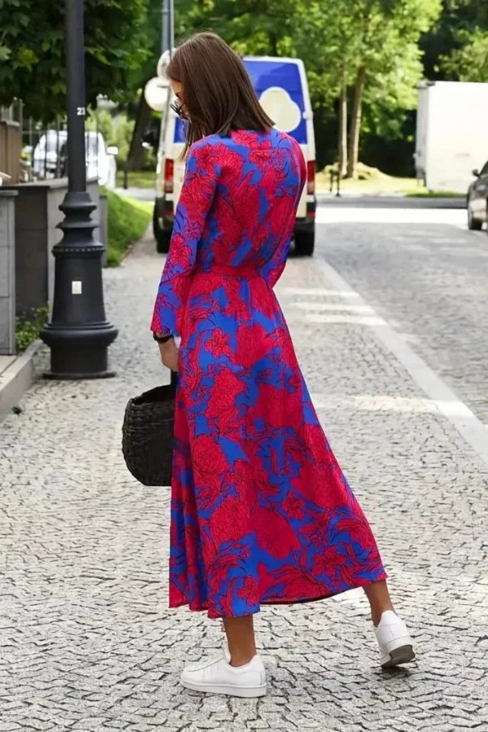 Model walking in Kouvr's red floral long sleeve wrap midi dress