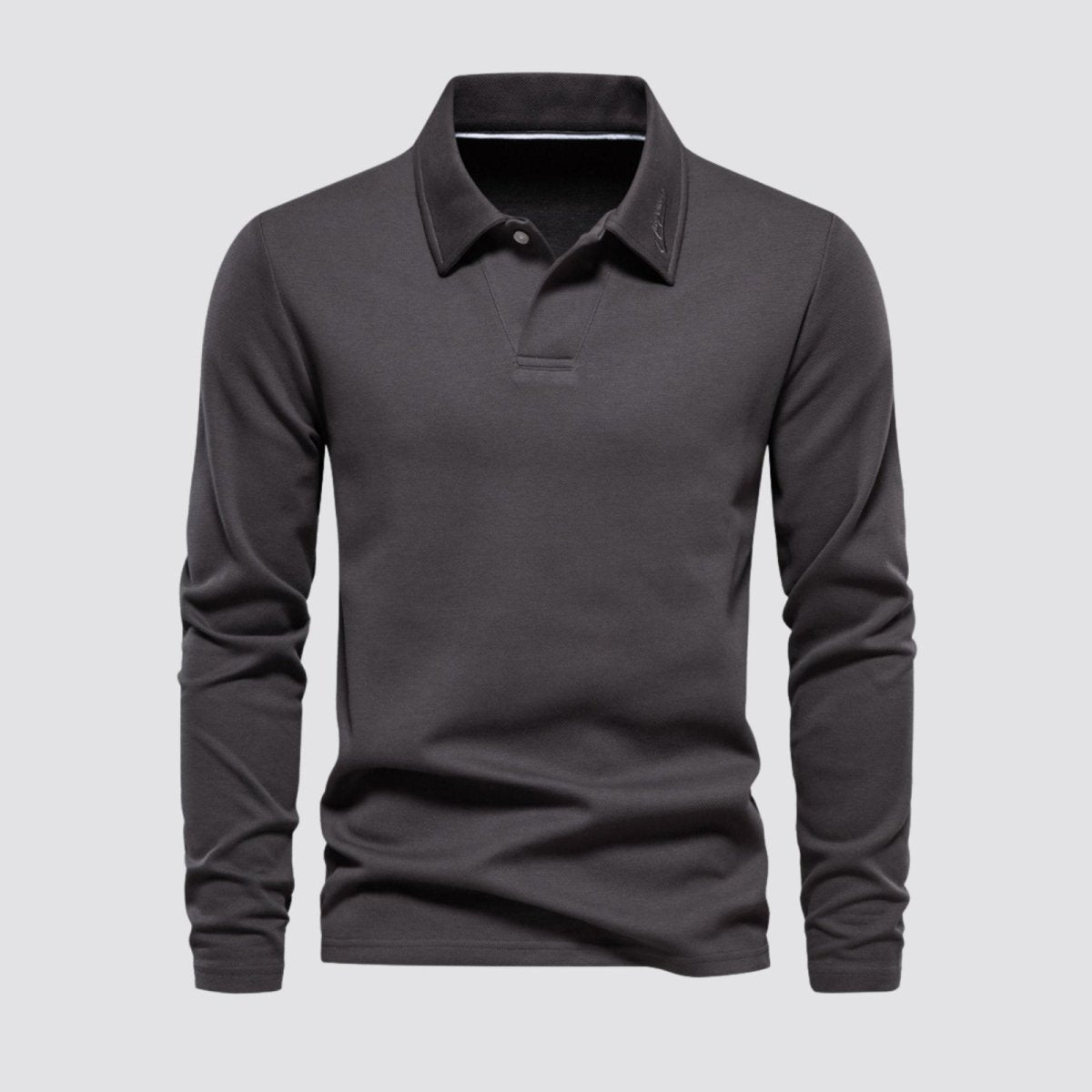 Product shot of the Kouvr men's long sleeve polo in charcoal, showing the collar, placket, and fabric texture from the front.