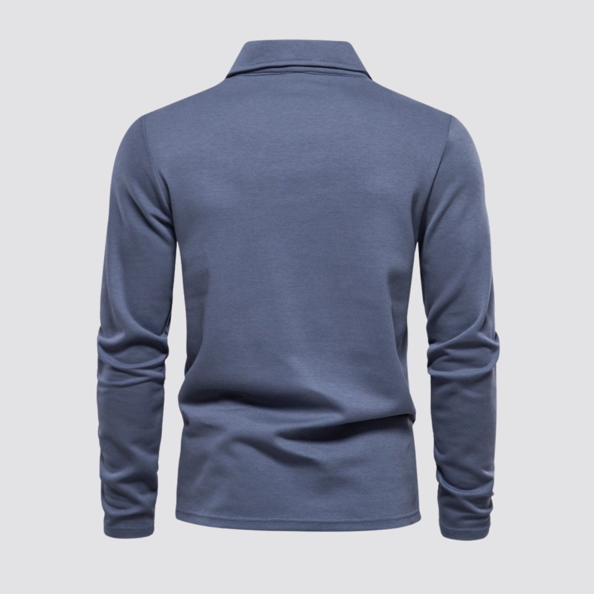 Back view of the Kouvr Rome Long Sleeve Polo in slate blue, laid flat to show the clean construction and silhouette.